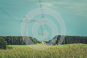 Electrical transmission tower against blue sky/Electrical transmission tower against blue sky. Toned