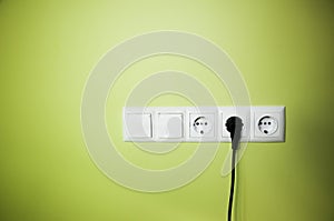 Electrical wall outlet / on green background