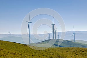 Electrical wind power mills over the blue sky