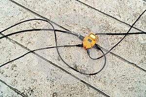 The electrical wire is connected to the orange electrical plug