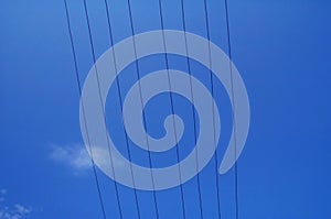 Electrical wires against blue sky