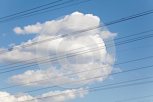 Electrical wires against blue sky and beautiful clouds