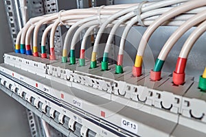 Electrical wires or cables are connected to circuit breakers.