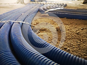 electrical wires in corrugation on a concrete floor in a house under construction