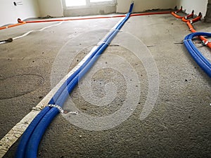 electrical wires in the corrugation on the insulation of the concrete floor in a house under construction