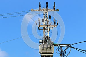 Electrical wires on a pole along which electricity flows photo