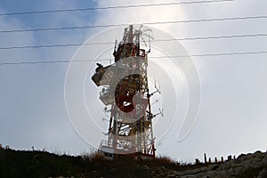 Electrical wires on a pole along which electricity flows photo