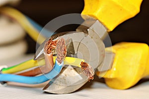 Electrical wires in the process of being cut with a side cutter.