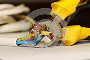 Electrical wires in the process of being cut with a side cutter.
