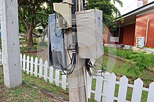 The electrical wiring control box is mounted on an outdoor pole.