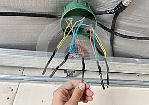 Electrical wiring of the junction box, installation, twisting of the box by an electrician.