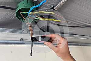 Electrical wiring of the junction box, installation, twisting of the box by an electrician.