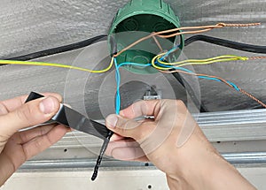 Electrical wiring of the junction box, installation, twisting of the box by an electrician.