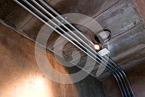 Electrical wiring work in a steel pipe of a house with a loft style design photo