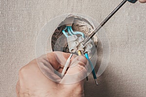 Electrician connects the wires for the socket and switch
