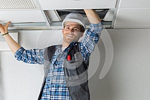 electrical worker wiring in ceiling