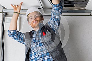 electrical worker wiring in ceiling
