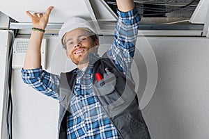 Electrical worker wiring in ceiling