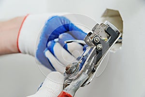 Electrican stripping insulation from wire. photo