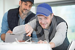 electrician with apprentice working in new home