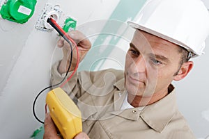 Electrician assembles standard bipolar wall socket