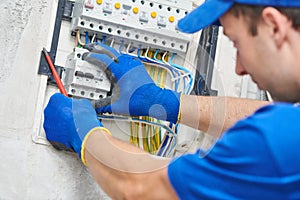 Electrician assembling power switchboard