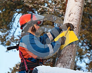 Electrician attaches to an electricity pylon yellow sign