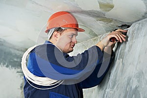 Electrician at cable wiring work