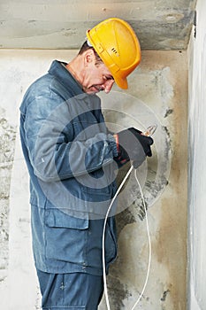 Electrician at cable wiring work