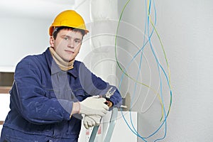 Electrician at cable wiring work