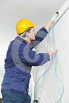 Electrician at cable wiring work