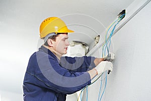 Electrician at cable wiring work