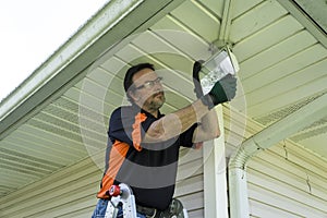 Electrician Changing A Bulb In A Outside Light Fixture