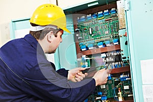 Electrician checking current at power line box