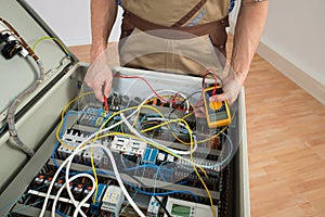 Electrician checking a fuse box