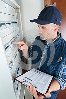 electrician checking fusebox