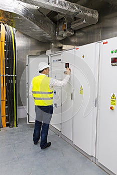 Electrician checking the power panel