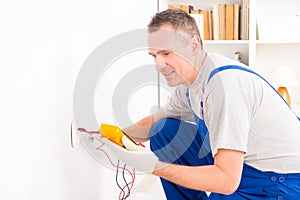 Electrician checking socket