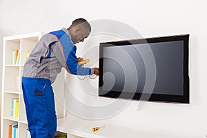 Electrician Checking Television With Multimeter photo