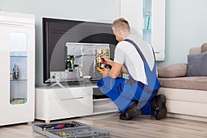 Electrician Checking Television