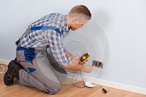 Electrician checking voltage with multimeter