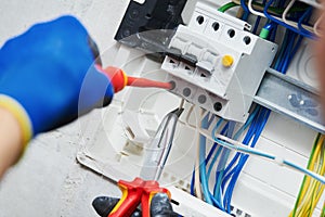 Electrician assembling power switchboard photo