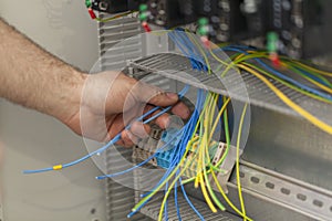 Electrician connecting wire on the control panel