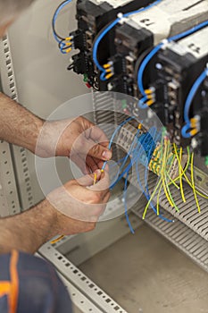 Electrician connecting wire on the control panel