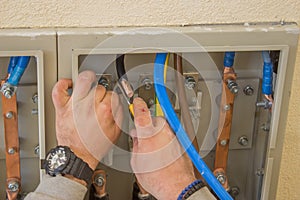 Electrician connecting wires in the electrical cabinet 2