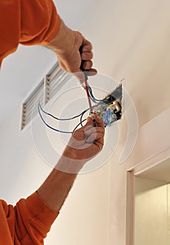 Electrician connecting the wiring during the renovation of the house