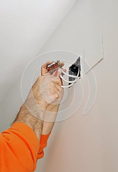 Electrician connecting the wiring during the renovation of the house