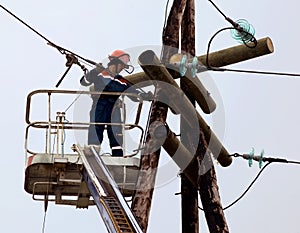 Electrician connects wires on the power line