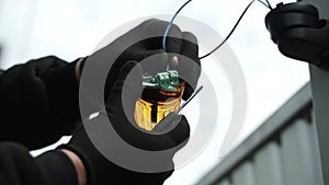 Electrician connects the yellow Signal Lamp for the gate. Warning yellow flash lamp