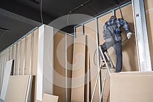 Caucasian Electrician Contractor Installing Electric Cable